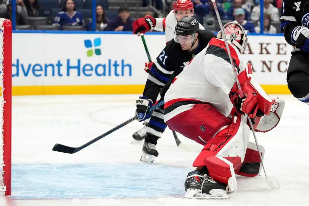 Tampa Bay Lightning center Brayden Point (21) watches his goal get past Carolina Hurricanes goaltender Pyotr Kochetkov (52) during the second period of an NHL hockey game Saturday, Dec. 20, 2025, in Tampa, Fla. (AP Photo/Chris O'Meara)