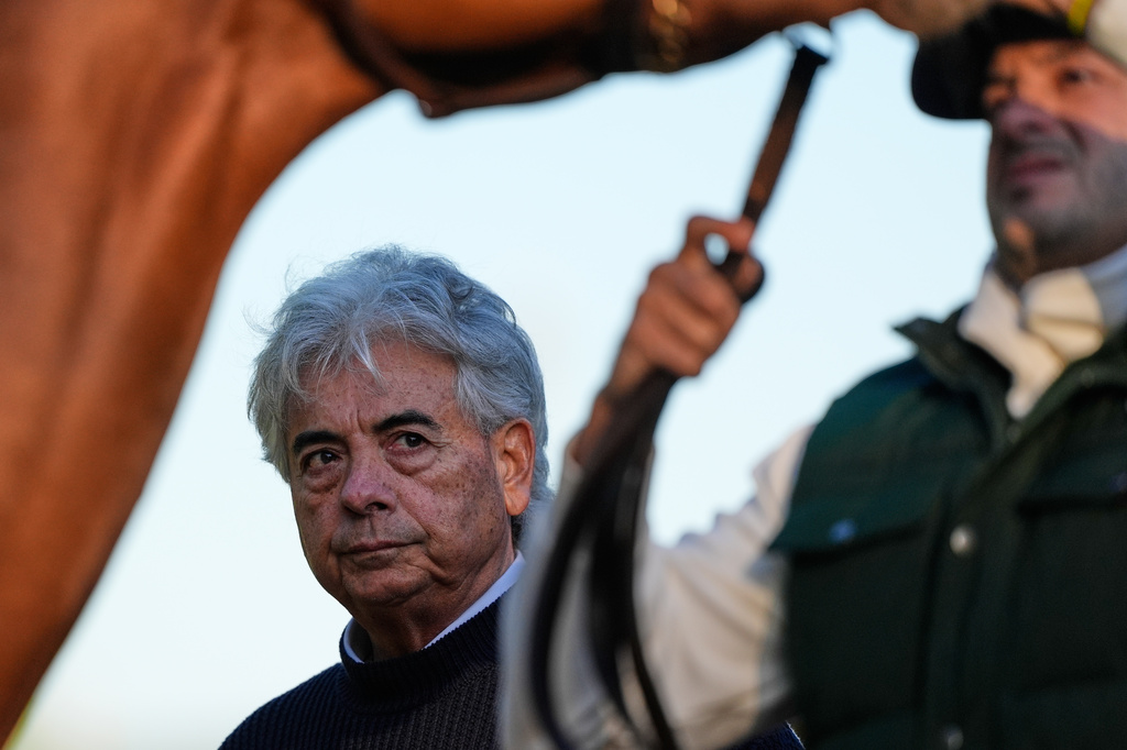Trainer Gustavo Delgado Sr. watches while his son Gustavo Delgado Sr. tends to Kentucky Derby entrant The Puma at Churchill Downs Thursday, April 30, 2026, in Louisville, Ky. (AP Photo/Charlie Riedel)