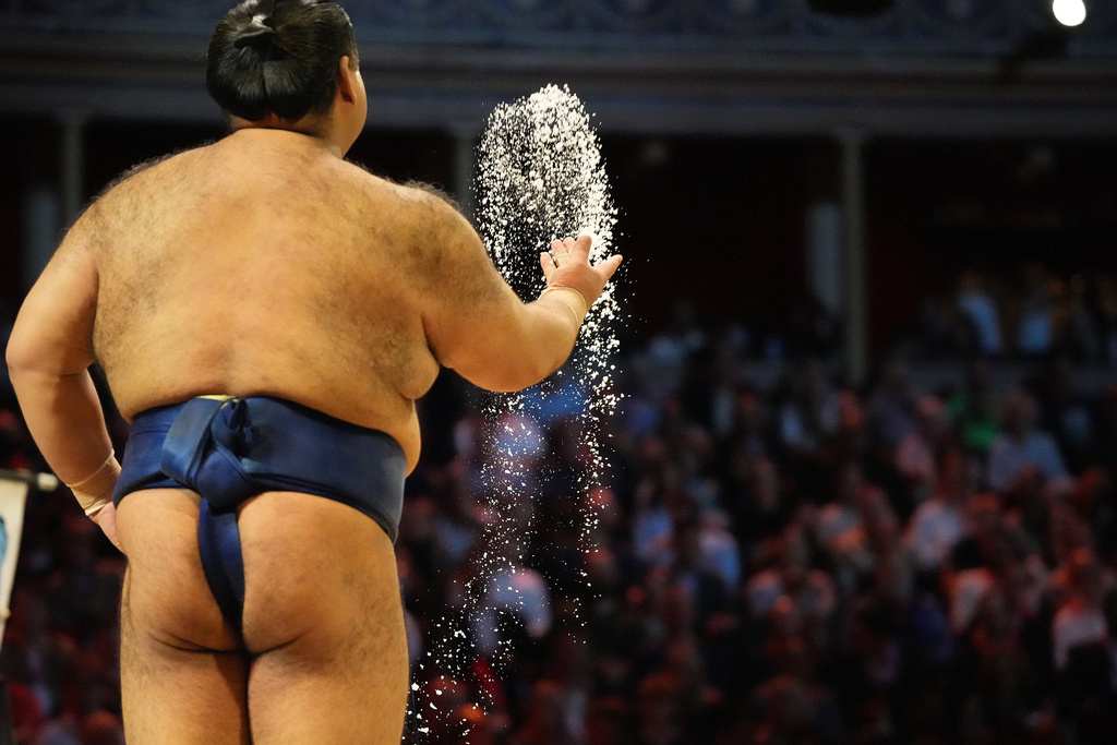 Sumo wrestler Takayasu throws salt before a bout during The Grand Sumo Tournament at the Royal Albert Hall in London, Wednesday, Oct. 15, 2025.(AP Photo/Frank Augstein)
