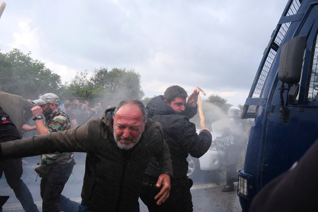 Police use tear gas against farmers during clashes with officers blocking their march to Chania's airport on Crete, Greece, Monday, Dec. 8, 2025, amid protests over delayed EU farm subsidies. (AP Photo/Giannis Angelakis)