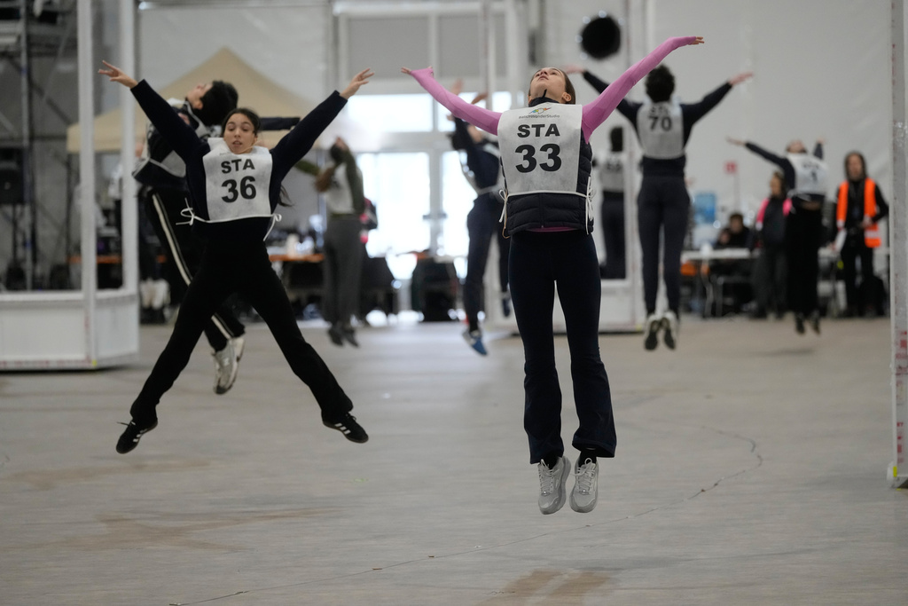 Volunteer dancers perform during rehearsals for the opening ceremony of the Milan Cortina 2026 Winter Olympic Games, at a compound in a big tent next to San Siro Stadium, in Milan, Italy, Saturday, Jan. 24, 2026. (AP Photo/Luca Bruno)