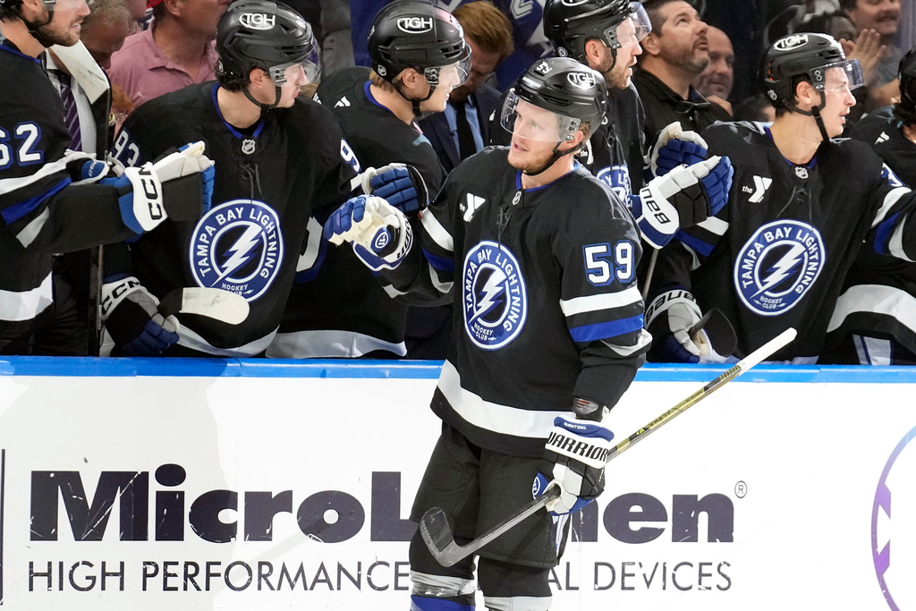 Tampa Bay Lightning center Jake Guentzel (59) celebrates with the bench after his goal against the Washington Capitals during the first period of an NHL hockey game Saturday, Nov. 8, 2025, in Tampa, Fla. (AP Photo/Chris O'Meara)