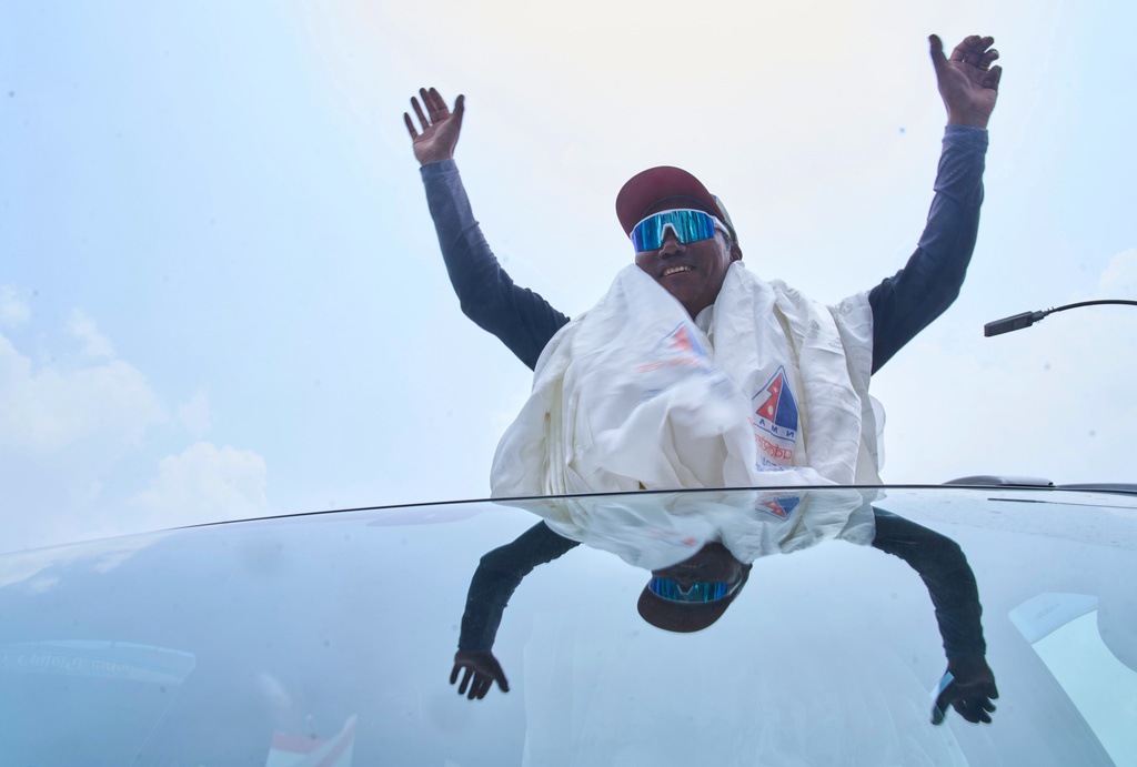 Renowned Sherpa mountain guide Kami Rita returning from Mount Everest after his record 32nd successful ascent, is welcomed as he arrives at an airport in Kathmandu, Nepal, Friday, May 22, 2026. (AP Photo/Niranjan Shrestha)