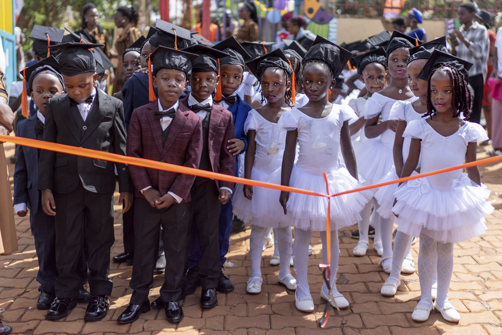 Children wait to walk down the aisle at their kindergarten graduation, Saturday, Nov. 23, 2024, in Kampala, Uganda. (AP Photo/David Goldman)