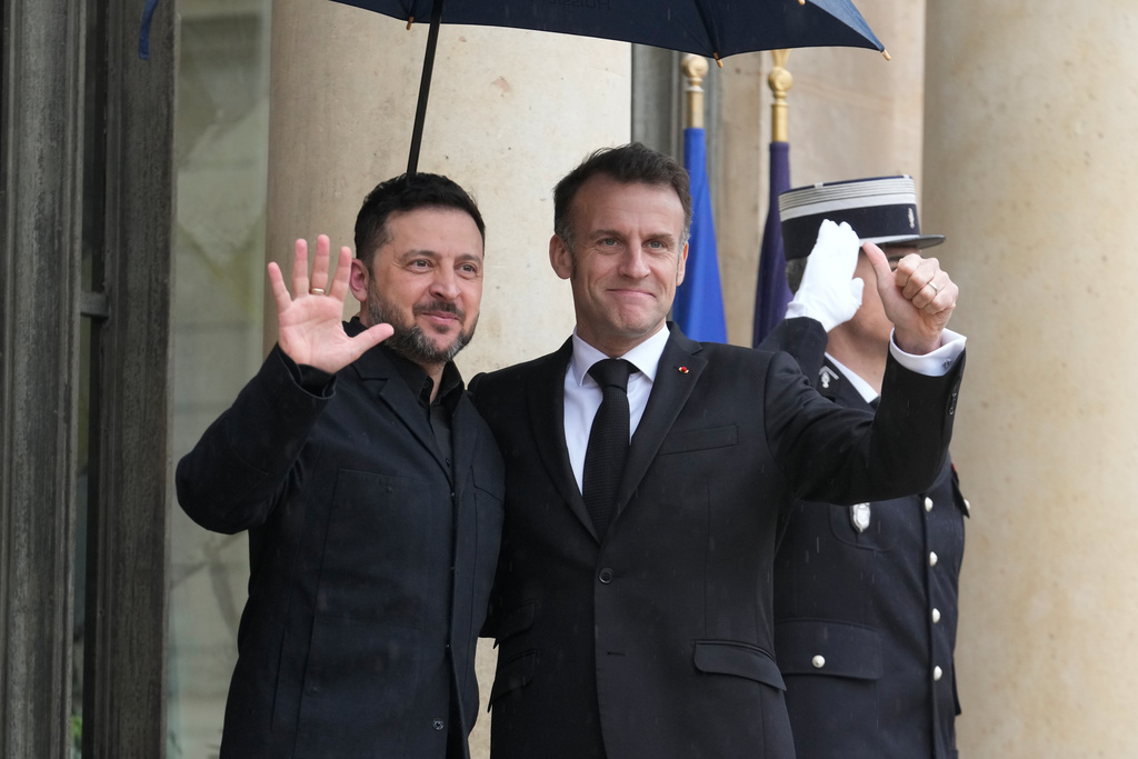 France's President Emmanuel Macron, right, welcomes Ukrainian President Volodymyr Zelenskyy prior to a meeting at the Elysee Palace, Friday, March 13, 2026, in Paris, France. (AP Photo/Michel Euler)