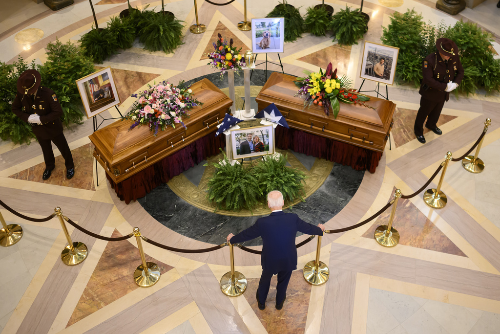 FILE - Former President Joe Biden pays his final respects to former Minnesota House Speaker Melissa Hortman, her husband, Mark, and their golden retriever, Gilbert, while they lie in state in the Minnesota Capitol rotunda in St. Paul, Friday, June 27, 2025. (Alex Kormann/Star Tribune via AP, File)