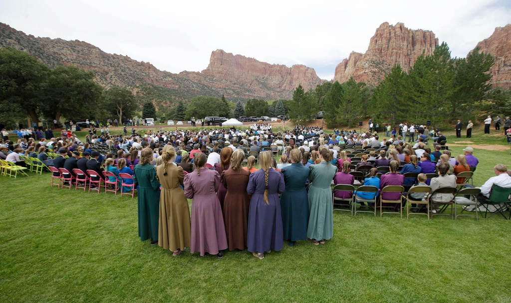 FILE - Two polygamous towns on the Utah-Arizona border hold a public memorial for women and children swept away in a deadly flash flood. (AP Photo/Rick Bowmer, File)