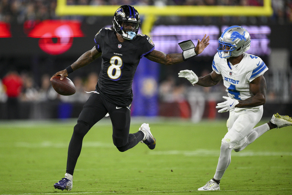 Baltimore Ravens quarterback Lamar Jackson (8) runs the ball as Detroit Lions cornerback DJ. Reed (4) tries to stop him during the first half of an NFL football game Monday, Sept. 22, 2025, in Baltimore. (AP Photo/Nick Wass)