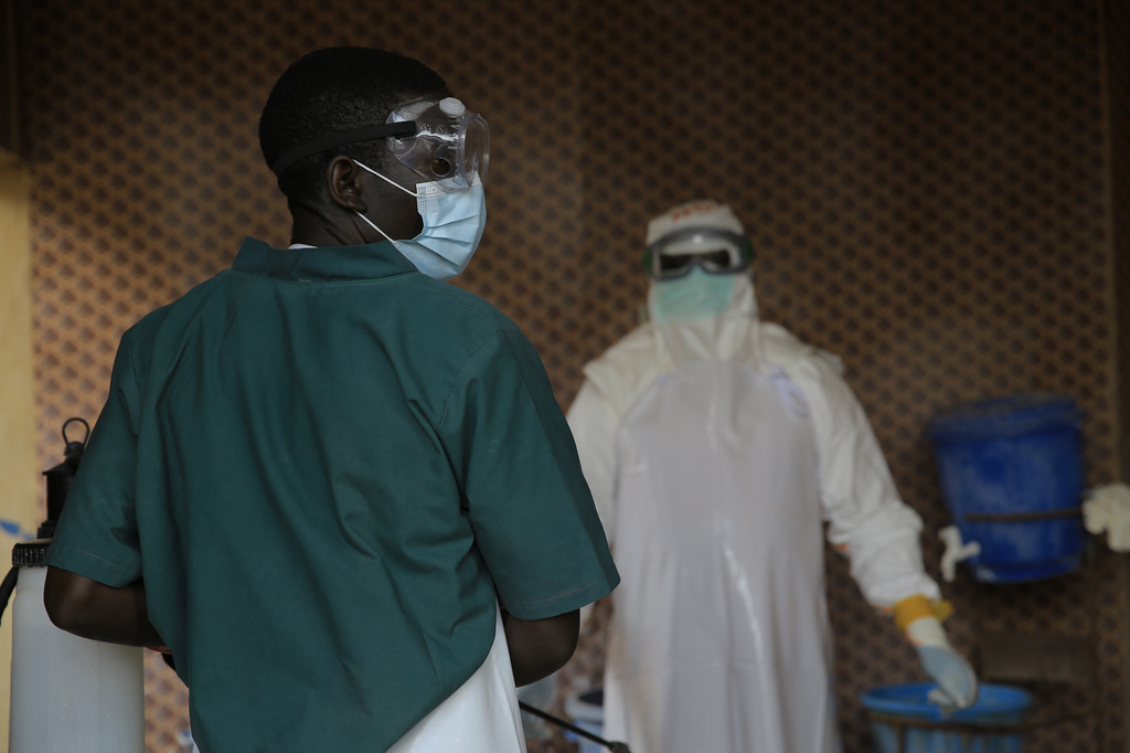 A healthcare worker is disinfected by his colleague inside a treatment center for Ebola patients in Beni, North Kivu province, eastern Congo, Saturday, Sept. 26, 2026. (AP Photo/Sebastien Kitsa Musayi)