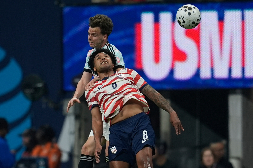 United States' Weston McKennie (8) and Belgium's Thomas Meunier battle for a head ball during the first half of an international friendly soccer match, Saturday, March 28, 2026, in Atlanta. (AP Photo/Mike Stewart)