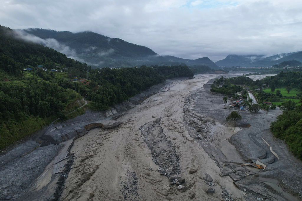 A drone view shows a major section of Pasang Lhamu highway washed away along swollen Trishuli river by recent flash floods cutting off Rasuwa district from Nuwakot area, Nepal, Monday, Aug. 31, 2026. (AP Photo/Rajesh Kumar Singh)