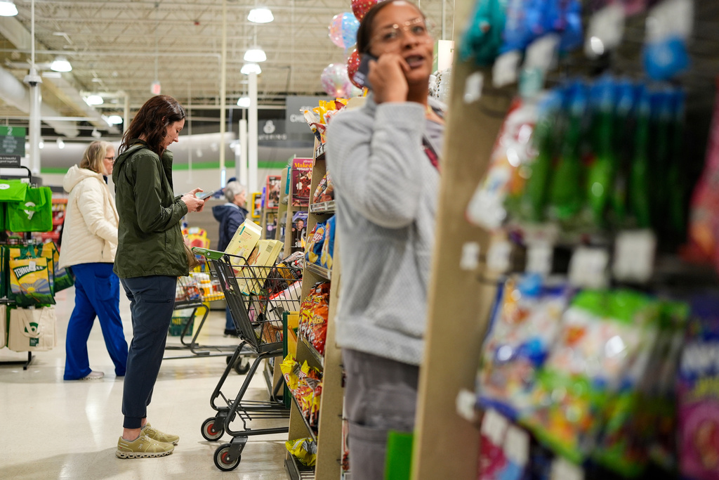 Shoppers wait in line to purchase groceries Wednesday, Jan. 21, 2026, in Nashville, Tenn., ahead of a winter storm expected to hit the state over the weekend. (AP Photo/George Walker IV)