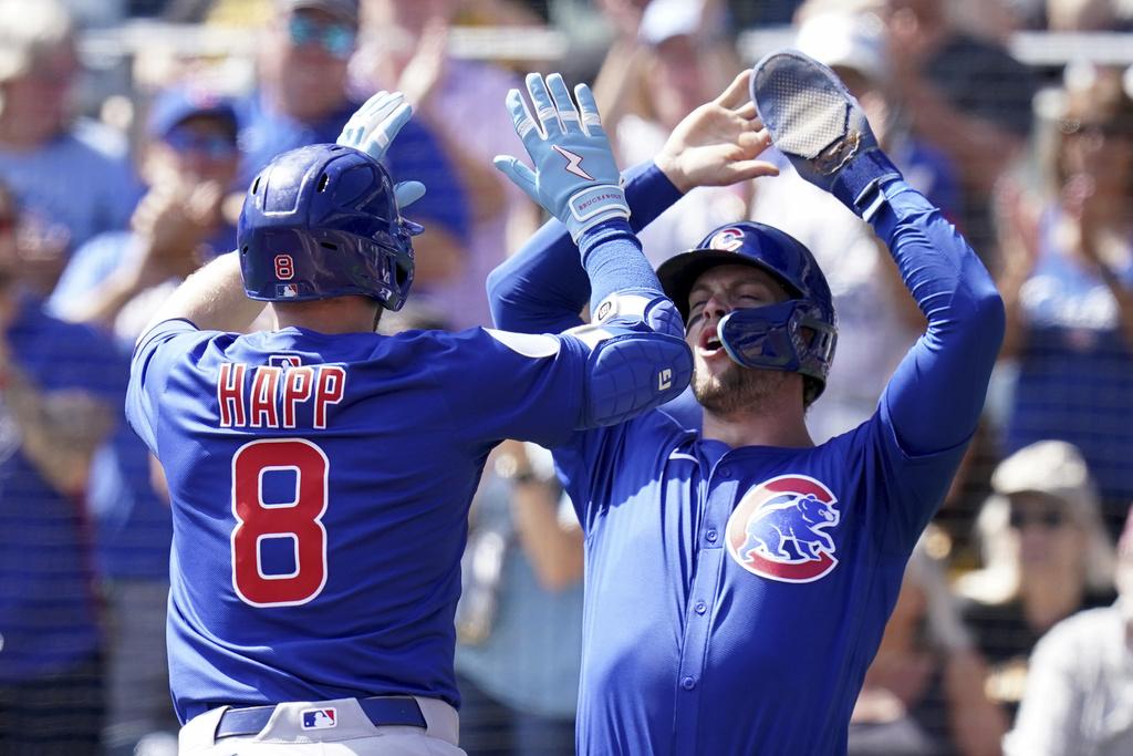 Chicago Cubs' Ian Happ, left, is greeted by Nico Hoerner, right, after hitting a two-run home run during the first inning of a baseball game against the Pittsburgh Pirates, Wednesday, Sept. 17, 2025, in Pittsburgh. (AP Photo/Matt Freed)