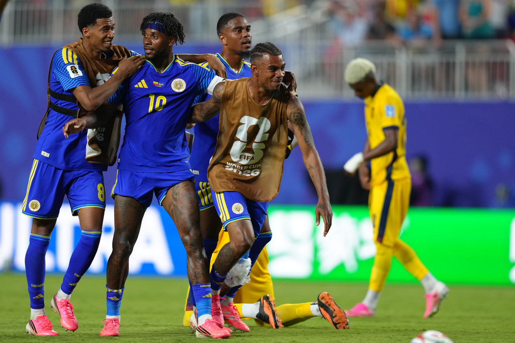 Curaçao's Leandro Bacuna and teammates celebrate after a draw against Ecuador during a World Cup Group E soccer match in Kansas City, Mo., Saturday, June 20, 2026. (AP Photo/Ed Zurga)