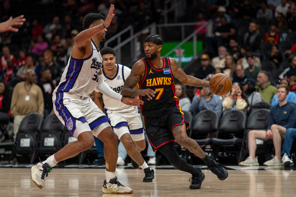 Atlanta Hawks guard Nickeil Alexander-Walker (7) drives with the ball during the first half of an NBA basketball game against the Sacramento Kings, Saturday, March 28, 2026, in Atlanta. (AP Photo/Erik Rank)