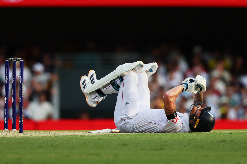 England's captain Ben Stokes lies down after being hit by the ball during the second Ashes cricket test match between Australia and England in Brisbane, Sunday, Dec. 7, 2025.. (AP Photo/Tertius Pickard)