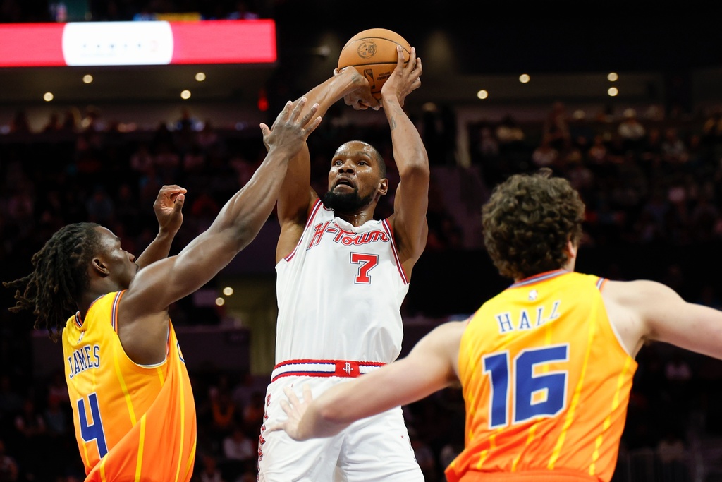 Houston Rockets forward Kevin Durant (7) looks to shoot against Charlotte Hornets guard Sion James (4) and center PJ Hall (16) during the first half of an NBA basketball game in Charlotte, N.C., Thursday, Feb. 19, 2026. (AP Photo/Nell Redmond)