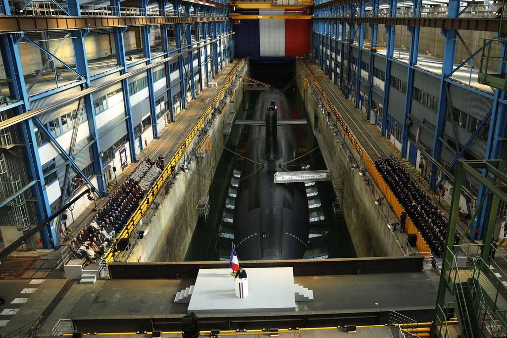 French President Emmanuel Macron delivers a speech next to the submarine 'Le Temeraire' (The Temerarious) at the Nuclear submarines Navy base of Ile Longue in Crozon, France, Monday March 2, 2026. (Yoan Valat/Pool Photo via AP)