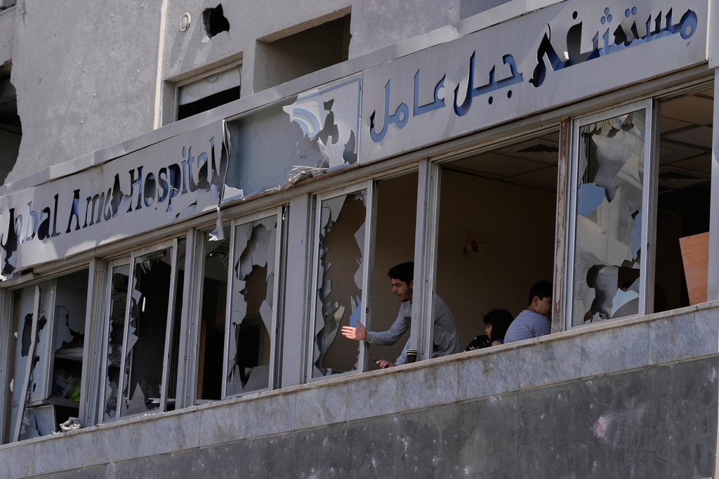 A man looks through the shattered windows of the damaged Jabal Amel Hospital, following Monday's Israeli airstrike that was hit a nearby building, in the southern port city of Tyre, Lebanon, Tuesday, June 2, 2026. (AP Photo/Mohammed Zaatari)