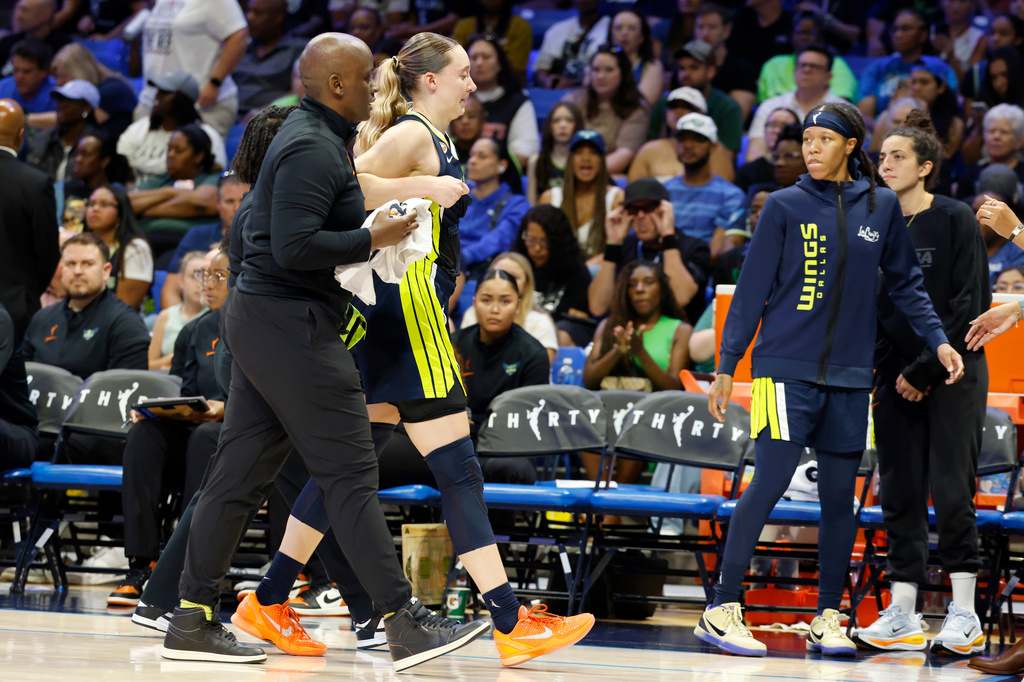 Dallas Wings guard Paige Bueckers leaves the court after a collision with Los Angeles Sparks forward Nneka Ogwumike during the second half of a WNBA basketball game, Sunday, July 19, 2026, in Arlington, Texas. (Elías Valverde II/The Dallas Morning News via AP)