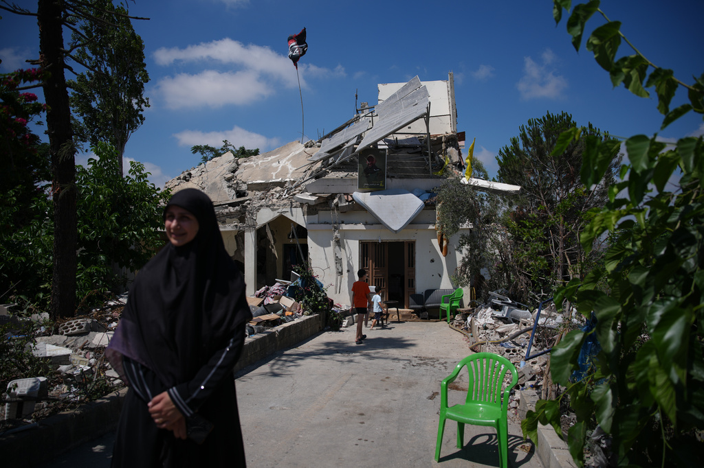Fatima Mokdad stands outside her home, which was destroyed in an Israeli airstrike during the Israel-Hezbollah war, where she and her family continue to live, using the only room that remained intact, in Froun village, southern Lebanon, Tuesday, July 21, 2026. (AP Photo/Hassan Ammar)
