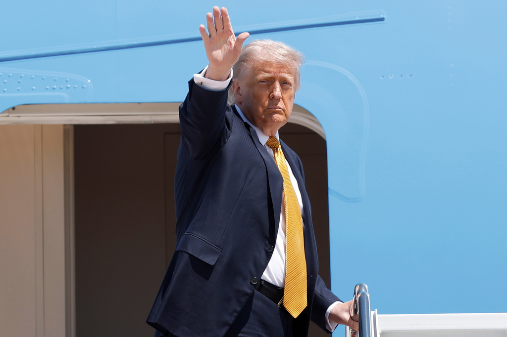 President Donald Trump waves from the stairs of Air Force One as he boards upon his arrival at Joint Base Andrews, Md., Tuesday, May 12, 2026, for a trip to China to meet President Xi Jinping. (AP Photo/Luis M. Alvarez)