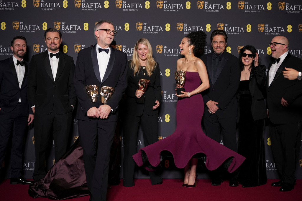 Andy Jurgensen, from left, Leonardo DiCaprio, Teyana Taylor, Paul Thomas Anderson, Sara Murphy, Chase Infiniti, Benicio Del Toro, Cassandra Kulukundis, and Michael Bauman pose with the awards for best director, cinematography, and adapted screenplay for 'One Battle After Another' at the 79th British Academy Film Awards, BAFTA's, in London, Sunday, Feb. 22, 2026. (AP Photo/Alastair Grant)