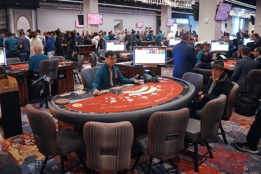 People gamble inside the casino floor during the opening of live table games at Resorts World New York City on Tuesday, April 28, 2026, in New York. (AP Photo/Andres Kudacki)
