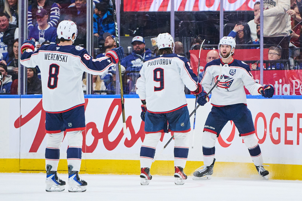 Columbus Blue Jackets' Adam Fantilli, right, celebrates after his goal against the Toronto Maple Leafs with Zach Werenski (8) and Ivan Provorov (9) during second-period NHL hockey game action in Toronto, Thursday, Nov. 20, 2025. (Sammy Kogan/The Canadian Press via AP)