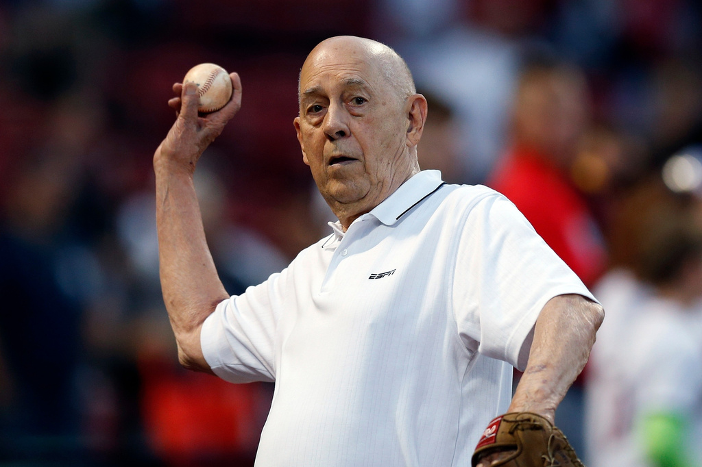 FILE - ESPN co-founder Bill Rasmussen tosses a ball before a baseball game between the Boston Red Sox and the New York Yankees in Boston, Sept. 8, 2019. (AP Photo/Michael Dwyer, File)