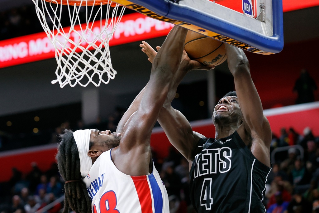 Detroit Pistons forward Isaiah Stewart, left, defends the basket against a shot by Brooklyn Nets guard Drake Powell (4) during the first half of an NBA basketball game Sunday, Feb. 1, 2026, in Detroit. (AP Photo/Duane Burleson)