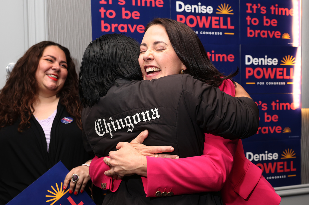 Denise Powell, candidate for the Democratic nomination to the House of Representatives in Nebraska's second district, right, hugs Jennifer Reyna, chair of Latino Caucus for the Democratic Party of Nebraska, during an election night watch party Wednesday, May 13, 2026, in Omaha, Neb. (AP Photo/Rebecca S. Gratz)