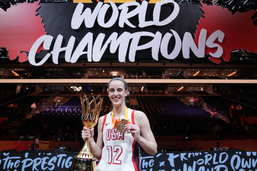 Caitlin Clark of the United States, poses with the trophy after the Women's Basketball World Cup final match between the United States and France in Berlin, Sunday, Sept. 13, 2026. (AP Photo/Ebrahim Noroozi)