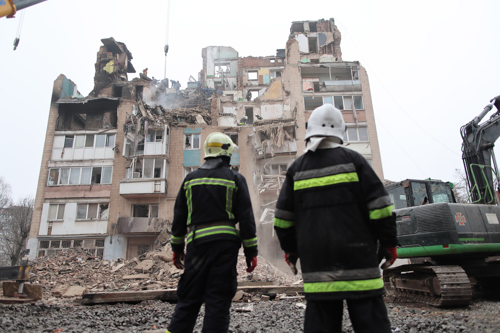 Rescue workers clear the rubble of a residential building which was heavily damaged by a Russian strike on Ternopil, Ukraine, Friday, Nov. 21, 2025. (AP Photo/Vlad Kravchuk)