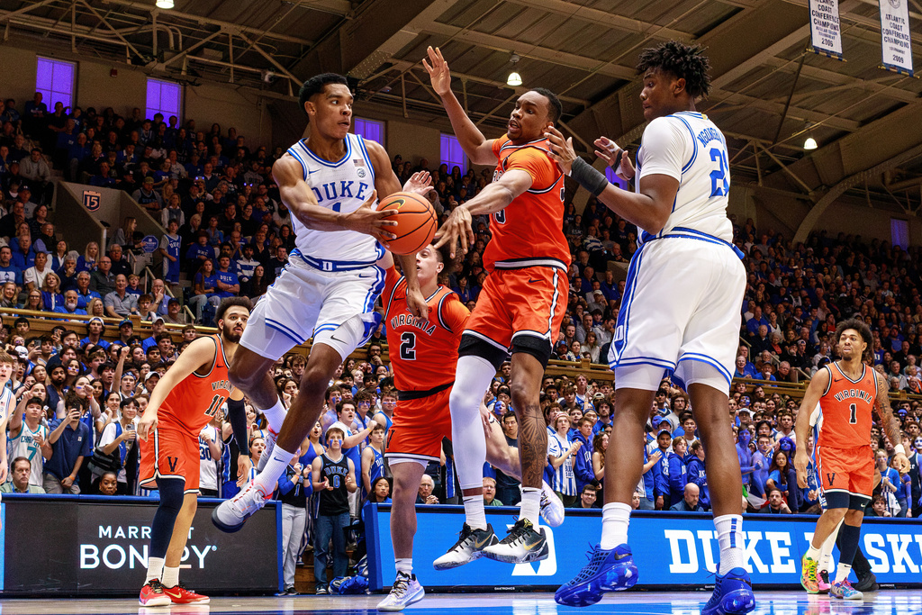 Duke's Caleb Foster (1) passes to Patrick Ngongba II (21) as Virginia's Chance Mallory (2) and Ugonna Onyenso, middle, defend during the second half of an NCAA college basketball game in Durham, N.C., Saturday, Feb. 28, 2026. (AP Photo/Ben McKeown)