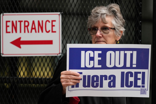 A woman holds a sign as she waits for U.S. Customs and Border Patrol Gregory Bovino outside federal court in Chicago, Tuesday, Oct. 28, 2025. (AP Photo/Nam Y. Huh) A woman holds a sign as she waits for U.S. Customs and Border Patrol Gregory Bovino outside federal court in Chicago, Tuesday, Oct. 28, 2025. (AP Photo/Nam Y. Huh)