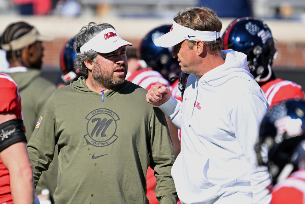 FILE - Mississippi defensive coordinator Pete Golding, left, and head coach Lane Kiffin talk during warm ups before an NCAA college football game against Louisiana Monroe in Oxford, Miss., Saturday, Nov. 18, 2023. (AP Photo/Thomas Graning, File)