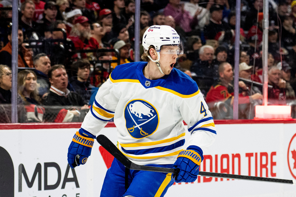 Buffalo Sabres' Bowen Byram (4) looks towards his teammates, not pictured, as he celebrates a goal during first period NHL hockey action against the Ottawa Senators in Ottawa, on Tuesday, Dec. 23, 2025. (Spencer Colby/The Canadian Press via AP)