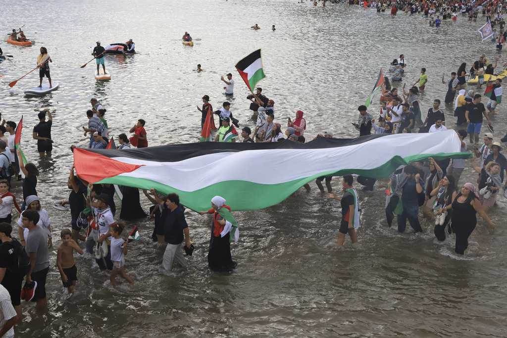 People gather to show support for the Global Sumud Flotilla ahead of its scheduled departure to deliver aid to Gaza amidst Israel's blockade on the Palestinian territory, in Sidi Bou Said port in Tunis, Tunisia, Wednesday, Sept. 10, 2025. (AP Photo/Anis Mili)