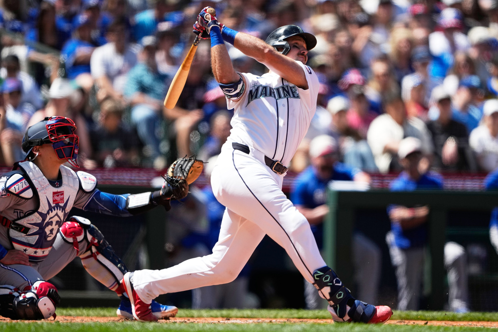 Seattle Mariners' Cal Raleigh follows through on a three-run home run against the Toronto Blue Jays during the sixth inning of a baseball game, Saturday, July 4, 2026, in Seattle. (AP Photo/Lindsey Wasson)