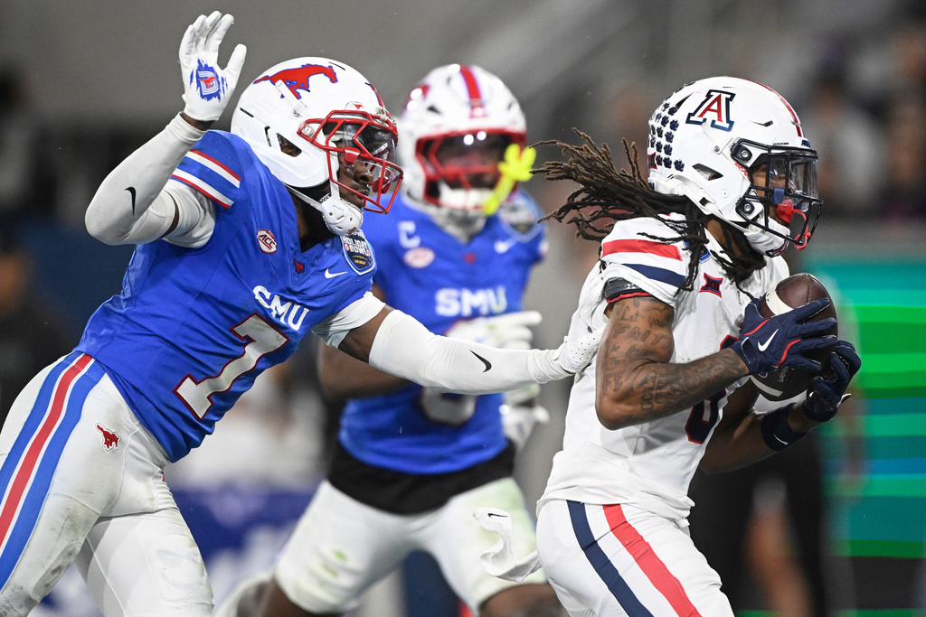 Arizona wide receiver Javin Whatley (6) makes a touchdown catch in front of SMU defensive back Deuce Harmon (7) during the second half of the Holiday Bowl NCAA college football game Friday, Jan. 2, 2026, in San Diego. (AP Photo/Denis Poroy)