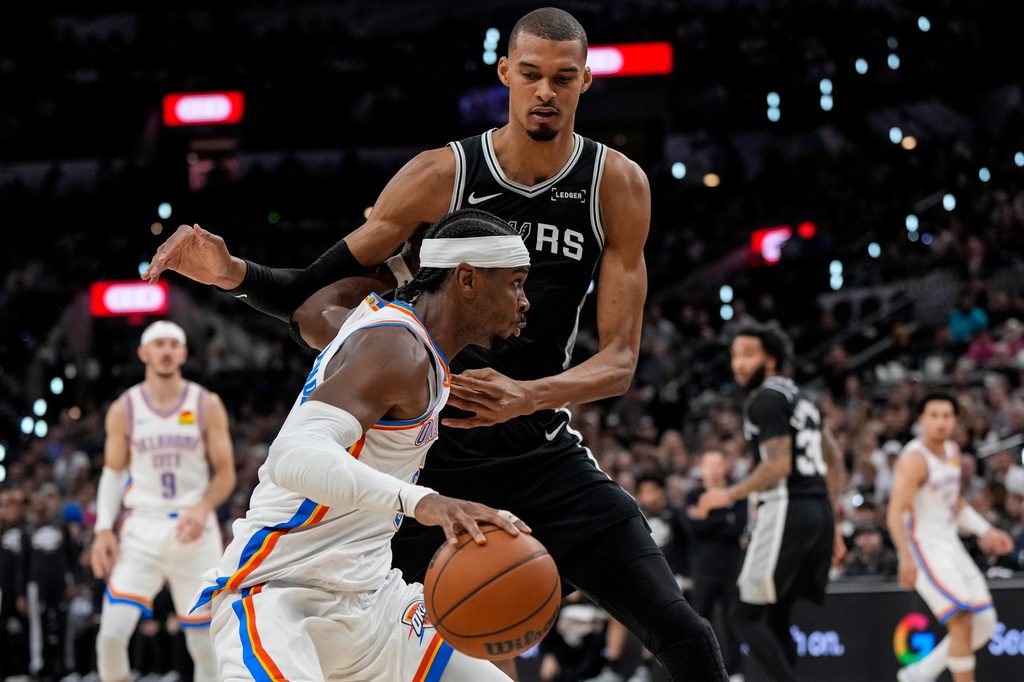 Oklahoma City Thunder guard Shai Gilgeous-Alexander (2) moves against San Antonio Spurs forward Victor Wembanyama (1) in the second half of Game 6 in the Western Conference finals NBA basketball playoffs series, Thursday, May 28, 2026, in San Antonio. (AP Photo/David J. Phillip)