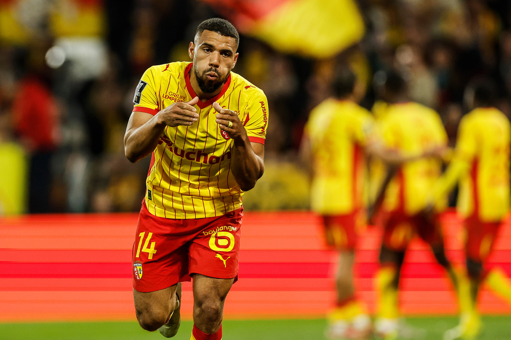 Lens's Matthieu Udol celebrates after scoring during the French League One soccer game between Lens and Angers, Friday, March 20,2 026, in Lens, France. (AP Photo/Jean-Francois Badias)