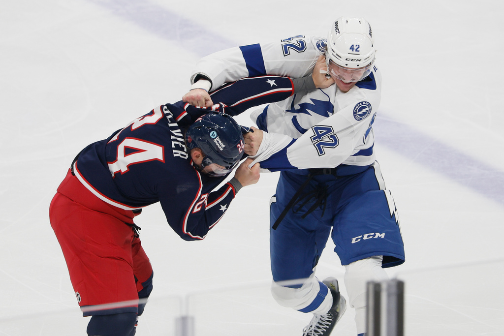 Columbus Blue Jackets' Mathieu Olivier, left, and Tampa Bay Lightning's Curtis Douglas, right, fight during the first period of an NHL hockey game, Saturday, Oct. 18, 2025, in Columbus, Ohio. (AP Photo/Jay LaPrete)