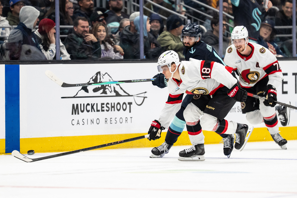 Ottawa Senators forward Tim Stutzle (18) skates against Seattle Kraken forward Matty Beniers, second from left, during the third period of an NHL hockey game Saturday, March 7, 2026, in Seattle. (AP Photo/Stephen Brashear)