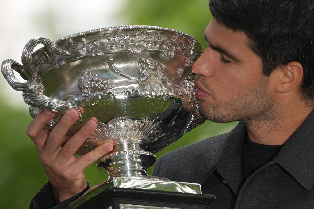Carlos Alcaraz of Spain kisses the Norman Brookes Challenge Cup the morning after defeating Novak Djokovic of Serbia in the men's singles final at the Australian Open tennis championship, in Melbourne, Australia, Monday, Feb. 2, 2026. (AP Photo/Dita Alangkara)