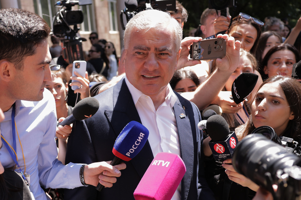 Russian-Armenian tycoon Samvel Karapetyan speaks to the media after voting at a polling station during a parliamentary election in Yerevan, Armenia, Sunday, June 7, 2026. (AP Photo/Anthony Pizzoferrato)