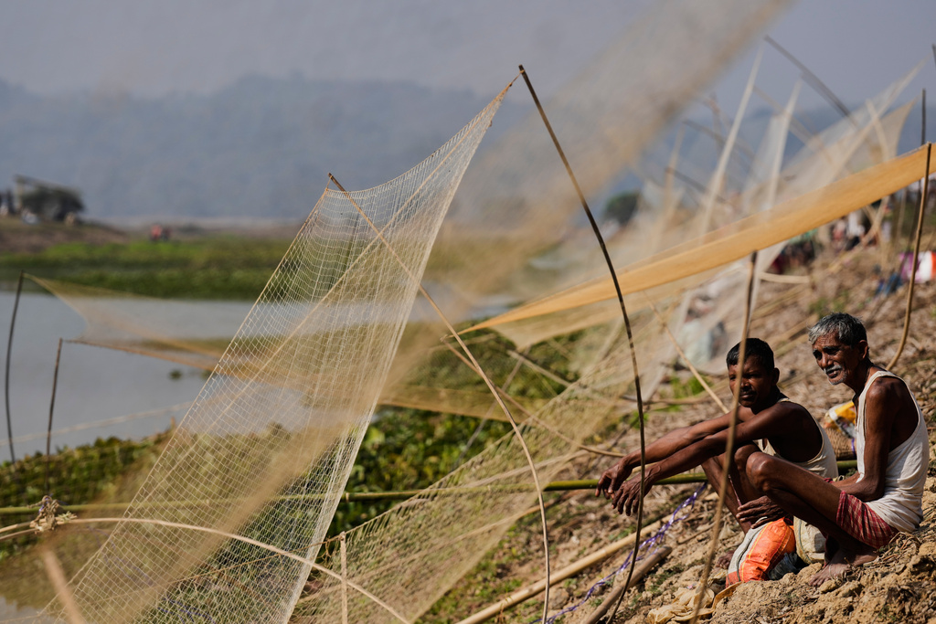 Villagers with their fishing nets wait to participate in a community fishing as part of Bhogali Bihu celebrations which mark the end of the harvest season at Jalikhora village east of Guwahati, India, Tuesday, Jan. 13, 2026. (AP Photo/Anupam Nath)
