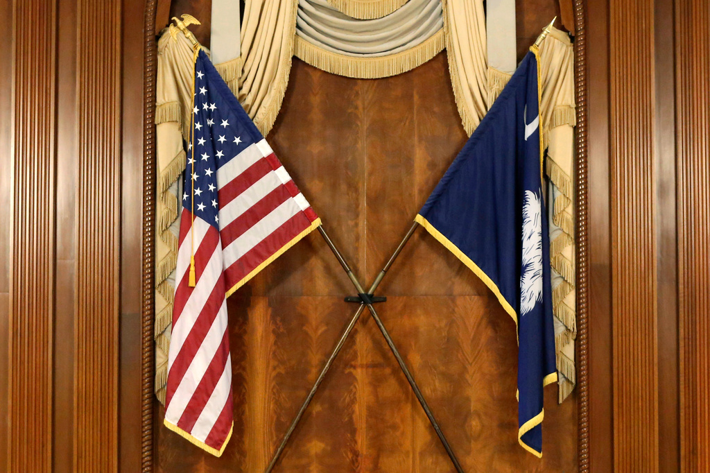 FILE - The U.S. and South Carolina flags hang in the South Carolina statehouse, March 16, 2021, in Columbia, S.C . (AP Photo/Jeffrey Collins, File)