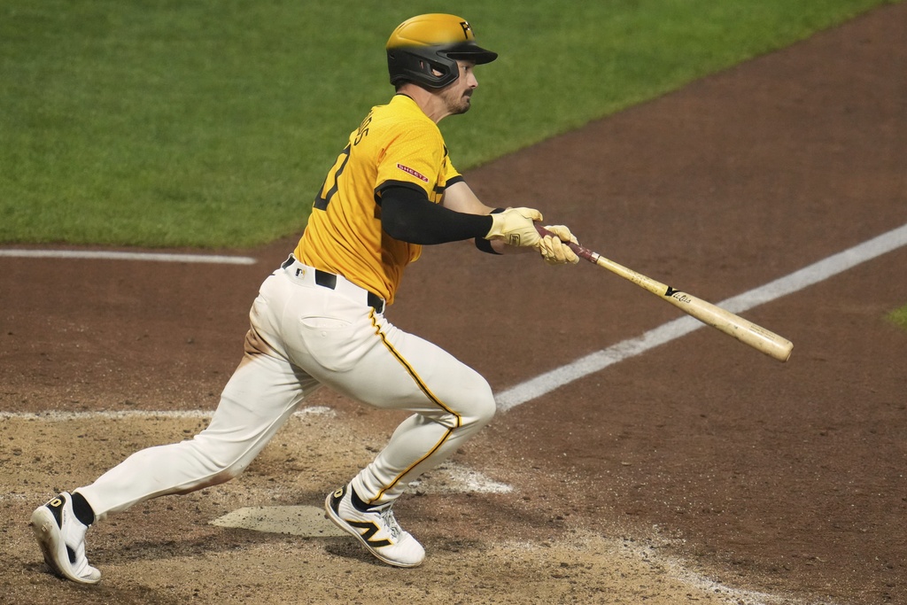 Pittsburgh Pirates' Bryan Reynolds follows through on a triple off Cincinnati Reds pitcher Tony Santillan, driving in two runs, during the eighth inning of a baseball game in Pittsburgh, Friday, Aug. 8, 2025. (AP Photo/Gene J. Puskar)
